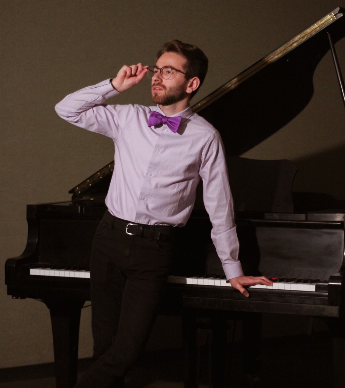 Jonah leaning on a piano